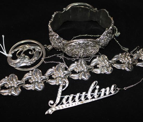 A silver bracelet, pendant and brooch and a white metal hinged bangle.